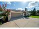 A two-car garage shows the long driveway, brick accents, and a meticulously maintained exterior at 365 N Spaulding Cv, Lake Mary, FL 32746