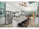 Open kitchen with island seating, stainless appliances, tile backsplash, and access to the backyard at 365 N Spaulding Cv, Lake Mary, FL 32746