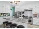 The modern kitchen features a granite island, stainless steel appliances, and ample white cabinetry at 365 N Spaulding Cv, Lake Mary, FL 32746