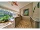 View of a pool bar area with brick flooring, granite countertop and cabinets in a screened-in lanai at 365 N Spaulding Cv, Lake Mary, FL 32746