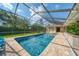 Relaxing pool and screened enclosure with blue skies and landscaped backyard at 365 N Spaulding Cv, Lake Mary, FL 32746
