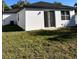 A shot of the backyard with a view of a small house, highlighted by a sliding glass door at 4420 W Gore Ave, Orlando,, FL 32811