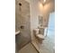Modern bathroom featuring a marble-tiled shower, white vanity, and sleek fixtures at 4420 W Gore Ave, Orlando,, FL 32811