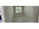 Well-lit bedroom with light gray walls and marble-patterned tile flooring at 4420 W Gore Ave, Orlando,, FL 32811