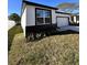 Single Gathering home front yard view showing landscaping and window at 4420 W Gore Ave, Orlando,, FL 32811
