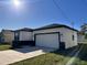 Front exterior view of a single-Gathering home with two car garage and a long driveway at 4420 W Gore Ave, Orlando,, FL 32811