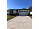 Front exterior view of single-Gathering home with two car garage at 4420 W Gore Ave, Orlando,, FL 32811