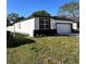 Well-maintained lawn of a modern house with a black roof and trim at 4420 W Gore Ave, Orlando,, FL 32811