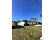 Side view of a modern home with a well-maintained lawn and a two-car garage at 4420 W Gore Ave, Orlando,, FL 32811