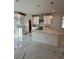 A modern kitchen with an island, marble floors, and modern light fixtures at 4420 W Gore Ave, Orlando,, FL 32811