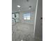 Bright open-concept living room with marble floors and neutral walls at 4420 W Gore Ave, Orlando,, FL 32811