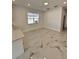 Open-concept living room featuring marble flooring, natural light, and neutral wall paint at 4420 W Gore Ave, Orlando,, FL 32811
