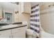 Functional bathroom featuring a vanity with sink, toilet, and a shower with striped curtain at 5526 P G A Blvd # 4911, Orlando, FL 32839