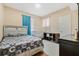 Cozy bedroom featuring a bed with stylish gray patterned bedding and a baby crib at 5526 P G A Blvd # 4911, Orlando, FL 32839