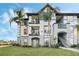 Inviting condo exterior with well-maintained landscaping and multiple balconies on a sunny day at 5526 P G A Blvd # 4911, Orlando, FL 32839
