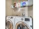 Well-organized laundry area featuring front-loading washer and dryer with overhead storage shelf at 5526 P G A Blvd # 4911, Orlando, FL 32839