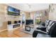 Inviting living room features fireplace, entertainment center, wood floors, and balcony access at 5526 P G A Blvd # 4911, Orlando, FL 32839