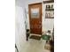 Unfinished basement with shelves, supplies, refrigerator, and a metal door at 6832 Oswego Dr, Mount Dora, FL 32757