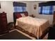 Bedroom featuring neutral walls, dark accents, a bed, and two windows at 6832 Oswego Dr, Mount Dora, FL 32757