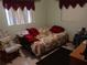 Bedroom featuring neutral walls, a patterned sofa, and one window at 6832 Oswego Dr, Mount Dora, FL 32757