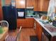 Functional kitchen featuring wood cabinets, black appliances, and a practical layout at 6832 Oswego Dr, Mount Dora, FL 32757