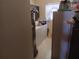 Modest laundry room with a washing machine, dryer, hot water tank and limited storage at 6832 Oswego Dr, Mount Dora, FL 32757