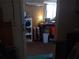 A cluttered storage room with an open door, shelving units, and a work bench at 6832 Oswego Dr, Mount Dora, FL 32757