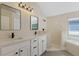 Stylish bathroom featuring double sinks, quartz countertops, and a walk-in shower at 9324 Pecky Cypress Way, Orlando, FL 32836