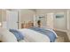 Bright bedroom with a large bed, modern dresser, and an ensuite bathroom entrance at 9324 Pecky Cypress Way, Orlando, FL 32836