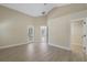 Open-concept bedroom featuring wood-look floors and a walk-in closet at 9324 Pecky Cypress Way, Orlando, FL 32836