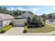 Charming single-story home with a well-manicured lawn, mature trees and a two-car garage at 9324 Pecky Cypress Way, Orlando, FL 32836