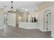Open-concept living space and kitchen featuring white cabinets and stainless steel appliances at 9324 Pecky Cypress Way, Orlando, FL 32836