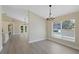 Dining and Living area with hardwood floors, neutral walls and large windows to let in natural light at 9324 Pecky Cypress Way, Orlando, FL 32836