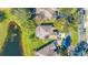 Aerial shot features the property with a pond view and verdant, mature landscaping at 9651 Old Marsh Ct, Orlando, FL 32832