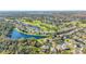 Aerial view showcases a community with lakes, a golf course, and beautiful landscaping at 9651 Old Marsh Ct, Orlando, FL 32832