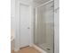 Modern bathroom featuring a tiled shower and a separate door at 9651 Old Marsh Ct, Orlando, FL 32832