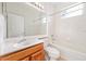 Bathroom with a large mirror, single sink vanity, shower-tub combo, and natural light from the window at 9651 Old Marsh Ct, Orlando, FL 32832