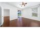 Comfortable bedroom with ceiling fan, hardwood floors, and a view of the outdoor space at 9651 Old Marsh Ct, Orlando, FL 32832