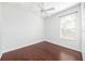 Bright bedroom features hardwood floors, a ceiling fan, and a window letting in natural light at 9651 Old Marsh Ct, Orlando, FL 32832