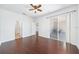 Spacious primary bedroom featuring a ceiling fan, wood flooring, and access to the patio at 9651 Old Marsh Ct, Orlando, FL 32832
