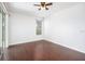 Bright bedroom with hardwood floors, ceiling fan and sliding glass door at 9651 Old Marsh Ct, Orlando, FL 32832