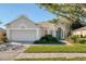 Charming one-story home with manicured lawn, lush landscaping, and a two-car garage at 9651 Old Marsh Ct, Orlando, FL 32832