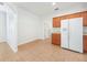 Bright kitchen with white appliances and wood cabinets and adjacent eat in area at 9651 Old Marsh Ct, Orlando, FL 32832