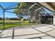 Spacious screened-in patio overlooks a tranquil pond and lush green backyard at 9651 Old Marsh Ct, Orlando, FL 32832