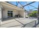 Covered patio features a ceiling fan, a dining set, and access to the screened lanai at 9651 Old Marsh Ct, Orlando, FL 32832