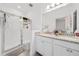 Bright bathroom with double sinks and a glass shower enclosure at 9790 Amber Chestnut Way, Winter Garden, FL 34787