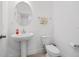 Bright powder room with a pedestal sink and neutral tile flooring at 9790 Amber Chestnut Way, Winter Garden, FL 34787