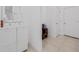 Bright hallway with neutral tile and a storage cabinet at 9790 Amber Chestnut Way, Winter Garden, FL 34787