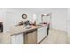 Close-up of kitchen island with granite countertop and stainless steel dishwasher at 9790 Amber Chestnut Way, Winter Garden, FL 34787