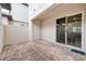 Covered patio with brick flooring, privacy fence, and sliding glass door at 9790 Amber Chestnut Way, Winter Garden, FL 34787
